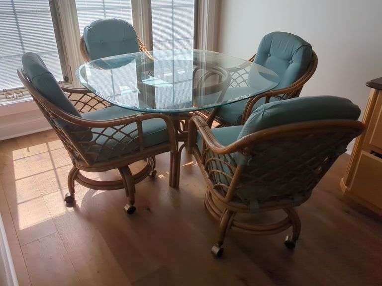 Rattan Dining Set with Glass Top Table and Four Rolling Chairs image