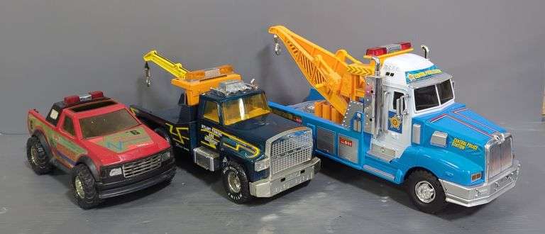 Nylint Tow Truck, Tonka Fire Rescue Truck, And Police Tow Truck Toy Vehicles image