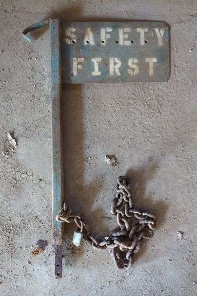 Metal "Safety First" Sign with Post and Chain
