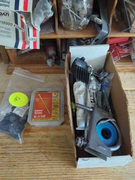 Wall-Mounted Wooden Shelf with Assorted Hardware and Tools