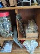 Wall-Mounted Wooden Shelf with Assorted Hardware and Tools