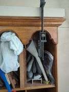 Wall-Mounted Wooden Shelf with Assorted Hardware and Tools