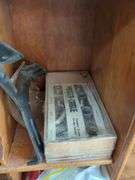 Wall-Mounted Wooden Shelf with Assorted Hardware and Tools