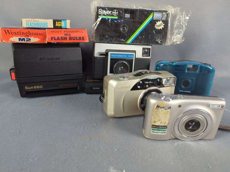 Collection of Cameras including Kodak Baby Brownie, Polaroid, Digital, and Flash Bulbs