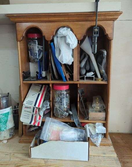 Wall-Mounted Wooden Shelf with Assorted Hardware and Tools