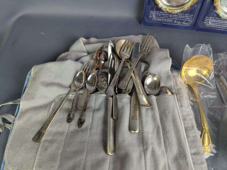Assorted Silver Plated Items: Flatware, Coasters, and Candlestick Holders