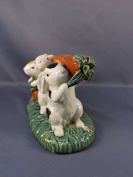 Whimsical Ceramic Figurine of Three Rabbits Carrying a Carrot