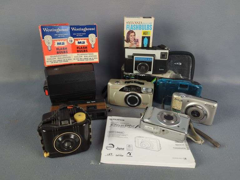 Collection of Cameras including Kodak Baby Brownie, Polaroid, Digital, and Flash Bulbs
