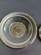 Assorted Silver Plated Items: Flatware, Coasters, and Candlestick Holders