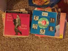 Collection of 45 RPM Records with Cases Including Elvis Presley, Shaun Cassidy, and More