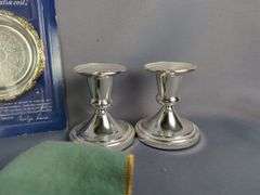 Assorted Silver Plated Items: Flatware, Coasters, and Candlestick Holders