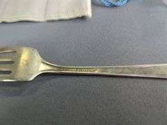 Assorted Silver Plated Items: Flatware, Coasters, and Candlestick Holders