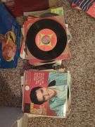 Collection of 45 RPM Records with Cases Including Elvis Presley, Shaun Cassidy, and More