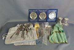 Assorted Silver Plated Items: Flatware, Coasters, and Candlestick Holders