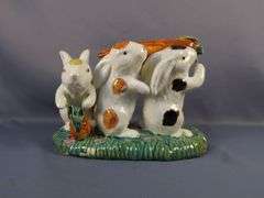 Whimsical Ceramic Figurine of Three Rabbits Carrying a Carrot