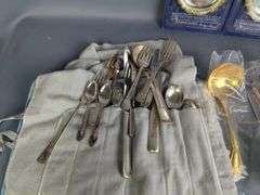 Assorted Silver Plated Items: Flatware, Coasters, and Candlestick Holders