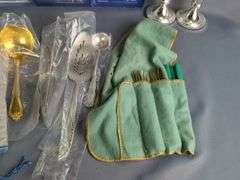 Assorted Silver Plated Items: Flatware, Coasters, and Candlestick Holders
