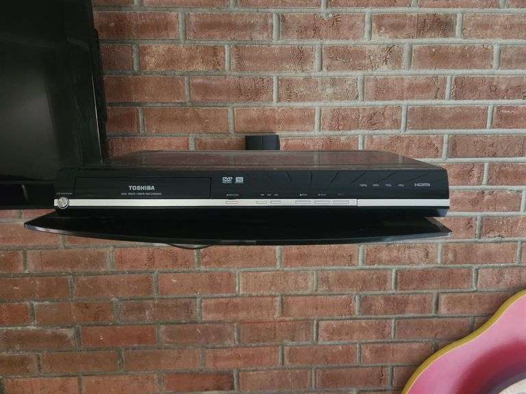 RCA Wall Mounted Television, And Toshiba DVD Player, Bidder Responsible For Proper Disassembly, Please Bring Proper Tools And Labor To Safely Remove