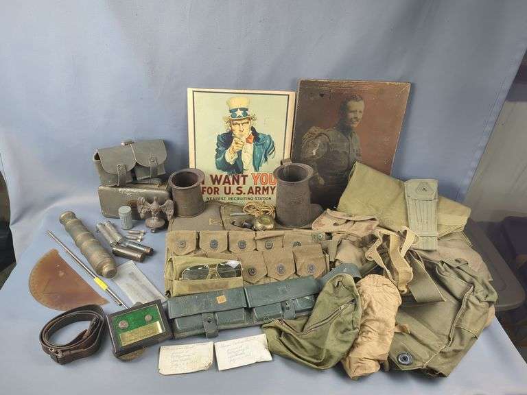 Militaria Including Civil War Union Uniform Buttons, Civil War Battlefield Bullets, Italian M1891 Calvary Bandolier, Swedish Ammo Pouch, US Ammo Belts, German 98K Cleaning Kit, US Kreamer Inc Creamers, Camouflage Face Paint, Sunglasses, Cast Iron Eagle Flag Topper, Gas Mask Pouches, And More image
