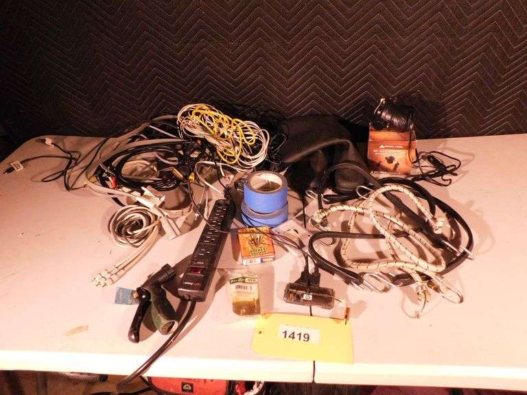 Misc lot of misc bungee cords, rubber boots, power strip, deck of playing cards, painters tape, RCA cables, Ozark trail air pump, hose nozzle
