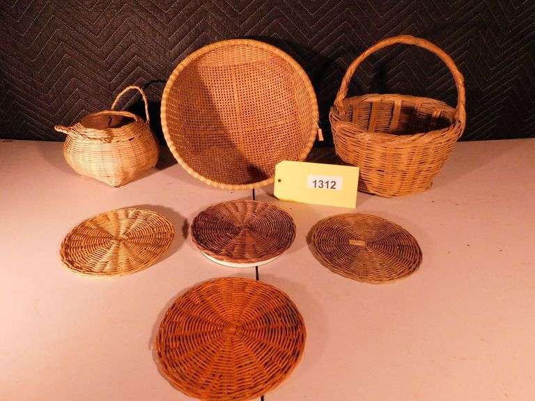 Lot of 7 Baskets and coasters ,single handle wicker picnic basket, circular wicker basket, 1 circ. wicker basket made in the People's Republic of China, 4 wicker coasters