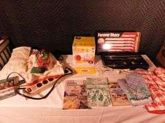 Lot of Kitchen items oven mitts, towels, shammy, citrus express, Boston Warehouse spreaders, cook books, Extension cords