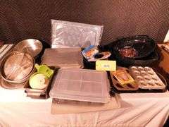 Lot of various baking items, cookie sheets, cake, muffin pans, placemat set, roast pan, chicken can rack