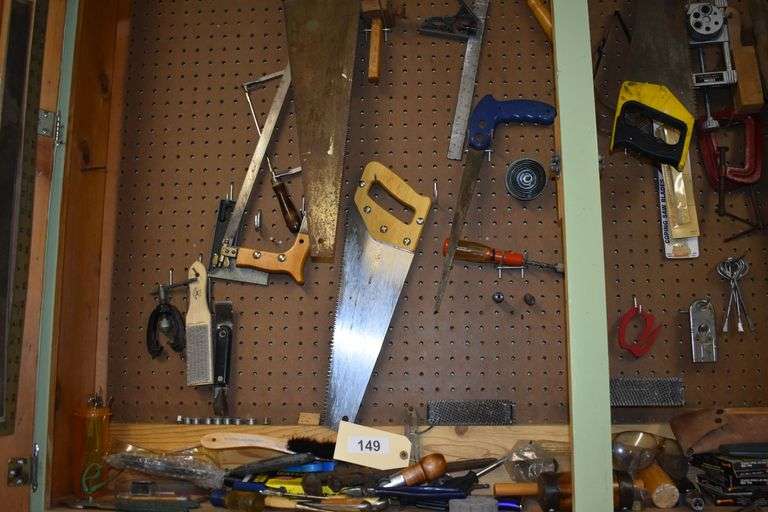 Numerous hand tools, fiels, hand saws, screw drivers, staples, hammers, clamps, chizzels, safety glasses, brushes, picks, rulers, etc.