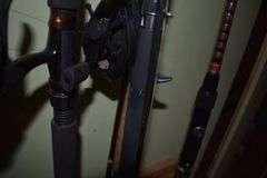 7 various sized fishing poles with reels and string