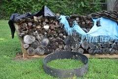 Rick of wood with metal fire ring