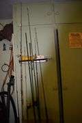7 various sized fishing poles with reels and string