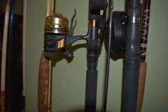 7 various sized fishing poles with reels and string