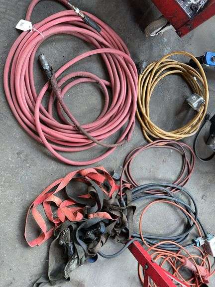 Air hose, electrical cords, ratchet straps, drop light image
