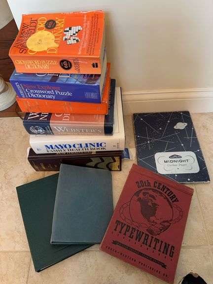Dictionaries, Mayo Clinic health book, Evansville City Directory, typewriting book, carbon paper image
