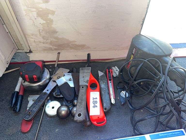 Spot light, taps measurers, box cutter. lighter, misc image