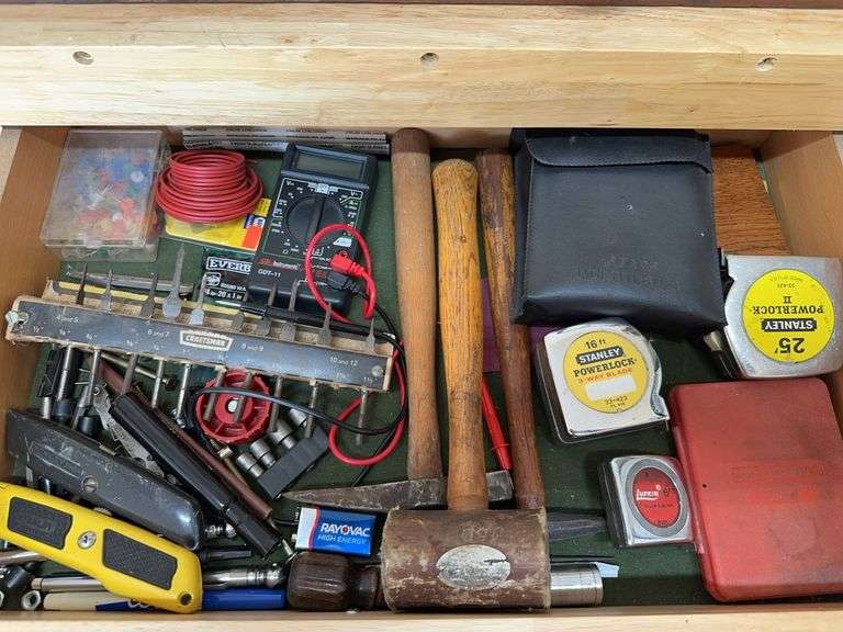 Contents of drawer: multimeter, tape measures, misc image