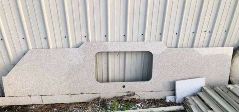 Quartz countertop with sink cutout with 4” side/back splash image