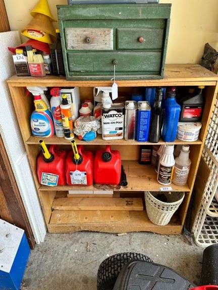Wooden shelf with Misc oil, funnels, cleaning products, oil image