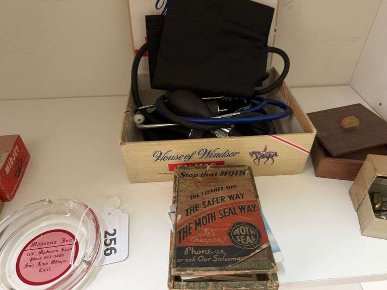 Lot of misc: ash tray   Vintage cigar box, vintage tie tac and cuff links, small wooden box,  vintage cigarette trading cards, stethoscope, vintage tin collapsible cup with lid, old lock image
