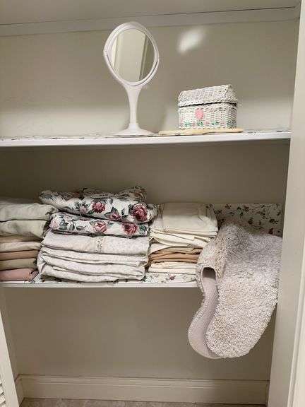 King size sheets, pillowcases, bath rugs, small wicker basket and 2 mirrors image