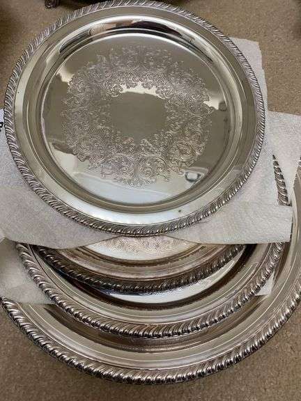 Four silver plated plates, one octagon shaped bowl, one round decorative tray on legs image