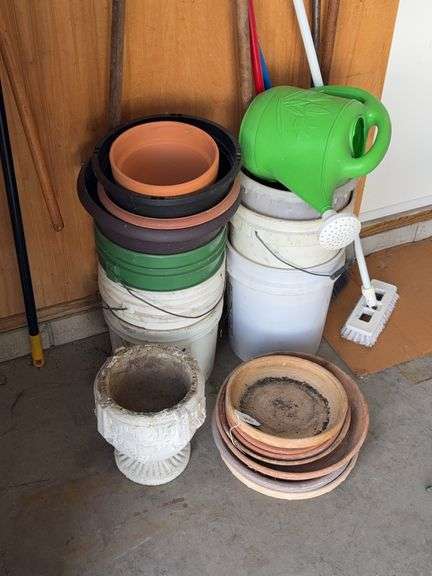 Plastic buckets, plastic sprinkler can, small concrete pot, planter under trays image