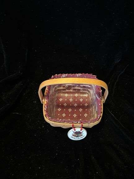 Longerberger classic purse with burgundy liner and maple leaf tie on and also has a patriotic extra liner . Dated and signed see picture . Classic berry basket with swinging handle that includes classic burgundy liner and protector dated 2000.