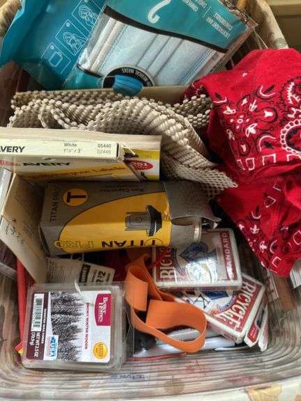 Various items in longaberger basket, playing cards, face masks
