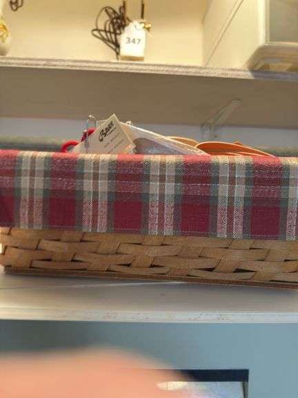 Longaberger divided basket with sewing items and plastic sewing basket with cutting mat and spools of thread