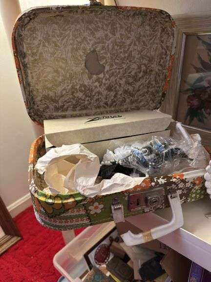 4 th shelf:  angel, vintage child’s suitcase( handle broken) 3 small brass lamps, 3 pictures , vase