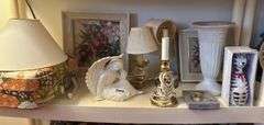 4 th shelf:  angel, vintage child’s suitcase( handle broken) 3 small brass lamps, 3 pictures , vase