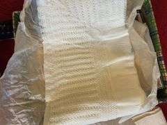 Box of crochet baby items and box of children’s shoes