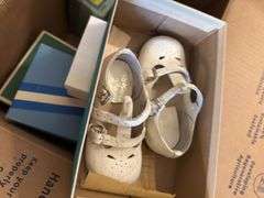 Box of crochet baby items and box of children’s shoes