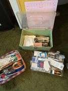 Longaberger divided basket with sewing items and plastic sewing basket with cutting mat and spools of thread